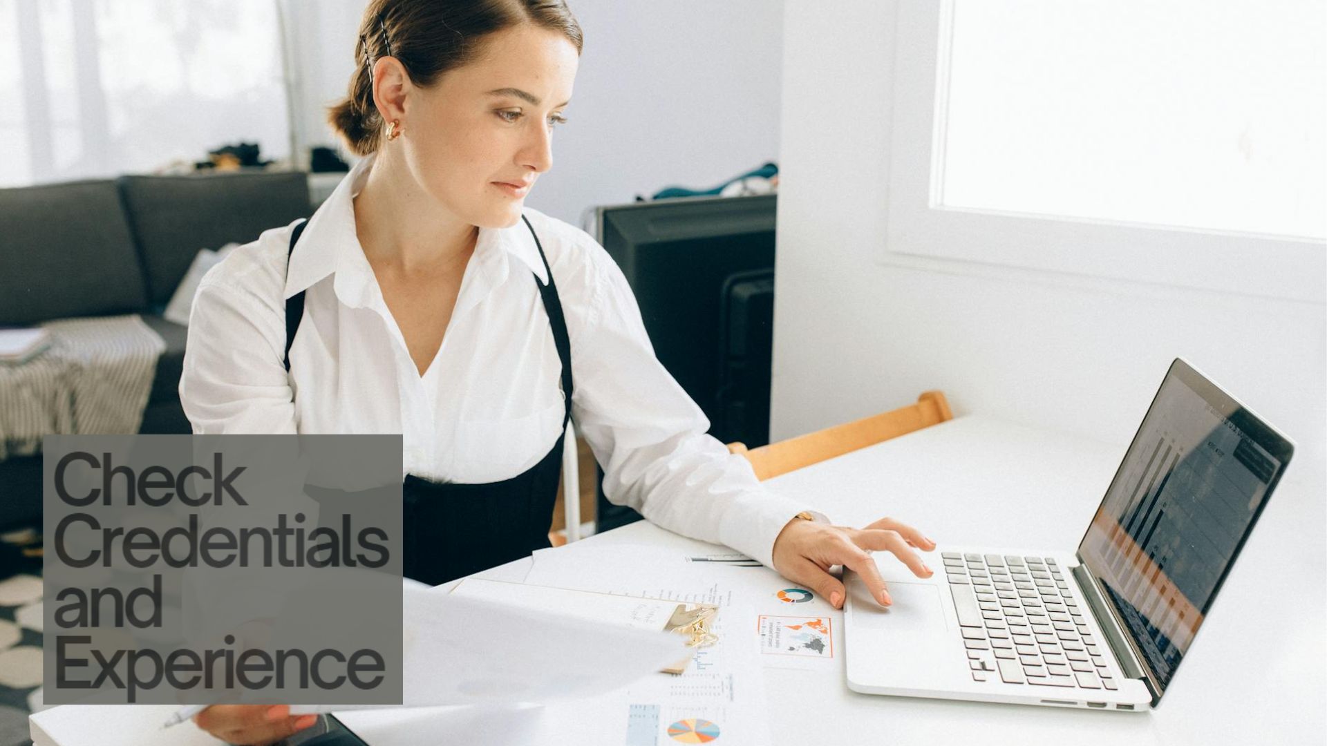 A woman checking the credentials and experience of a garage door service online