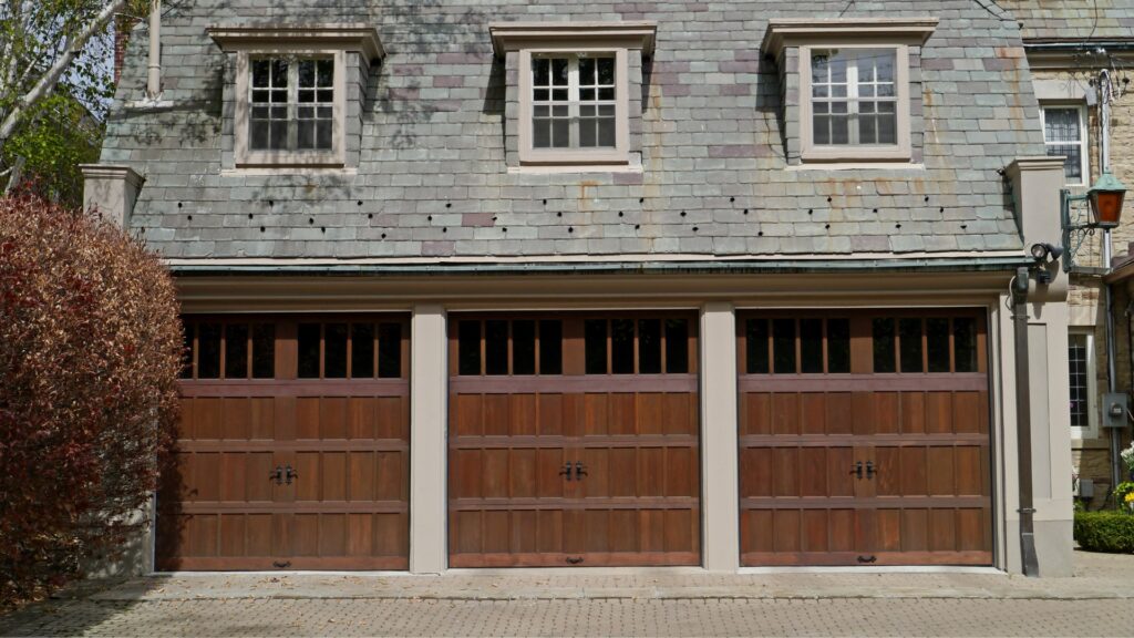 Three wood garage door with windows in a home in Des Moines