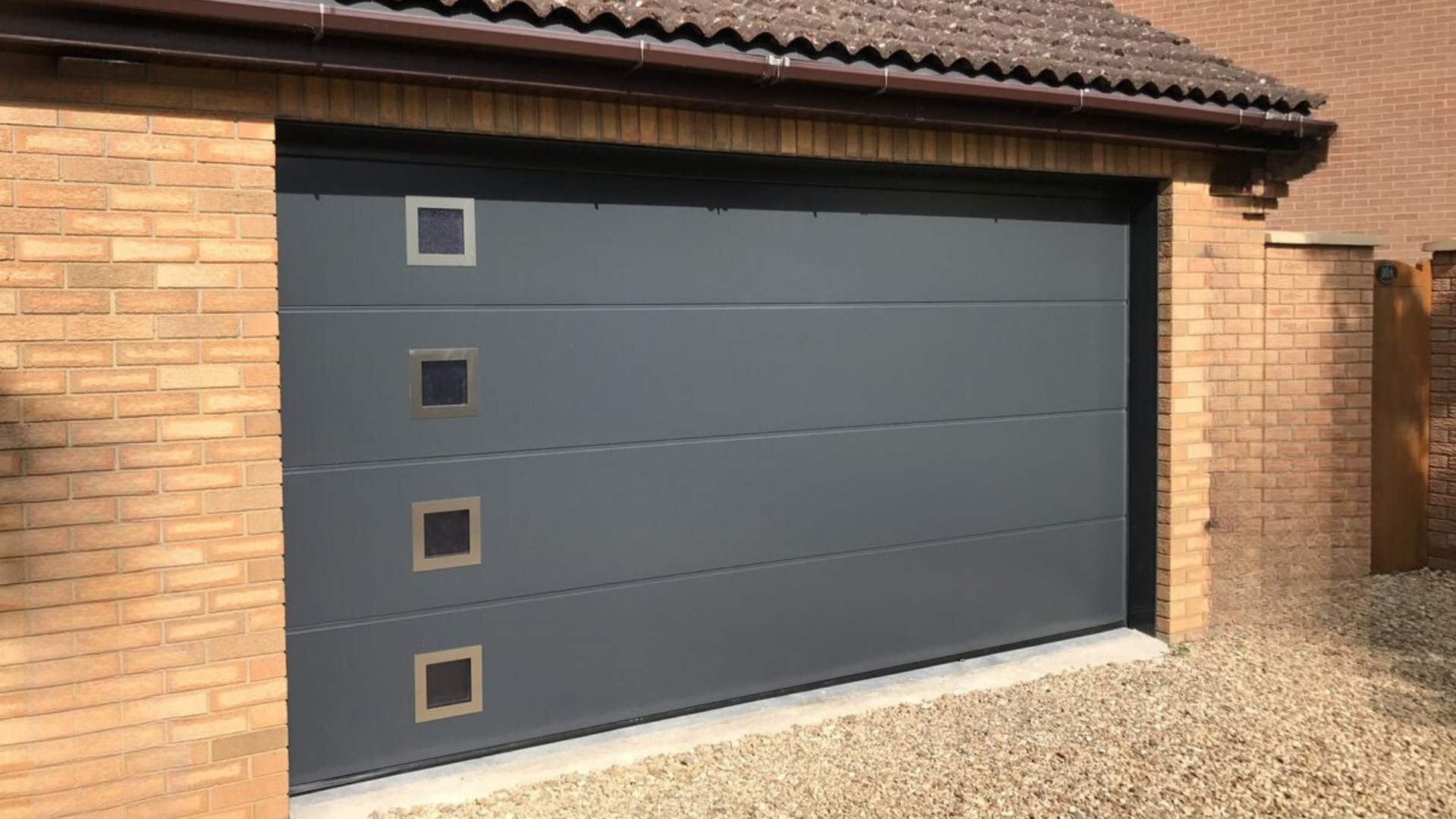 A gray sectional garage door installed in a home in Des Moines