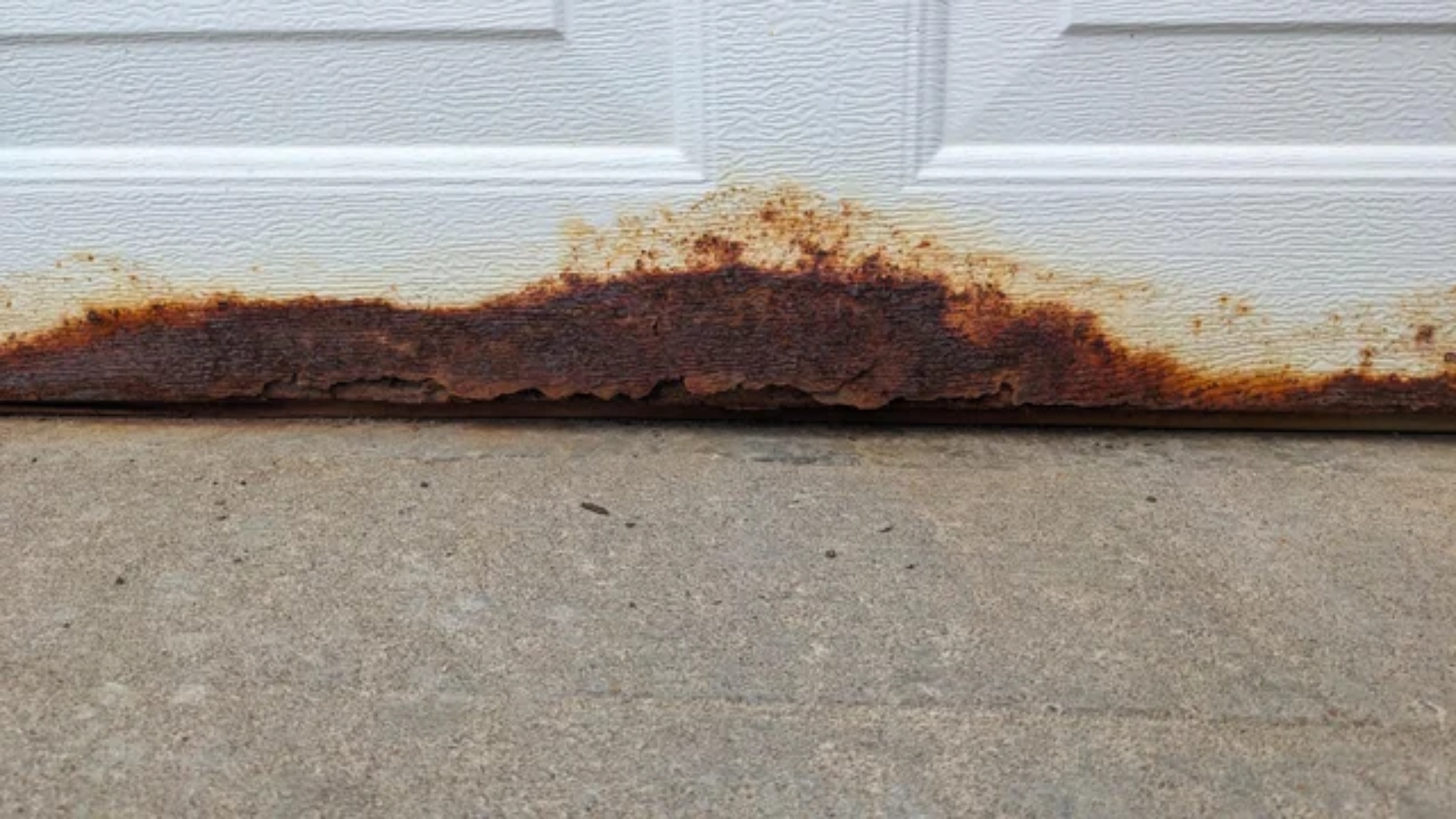 Bottom of the garage door with rust