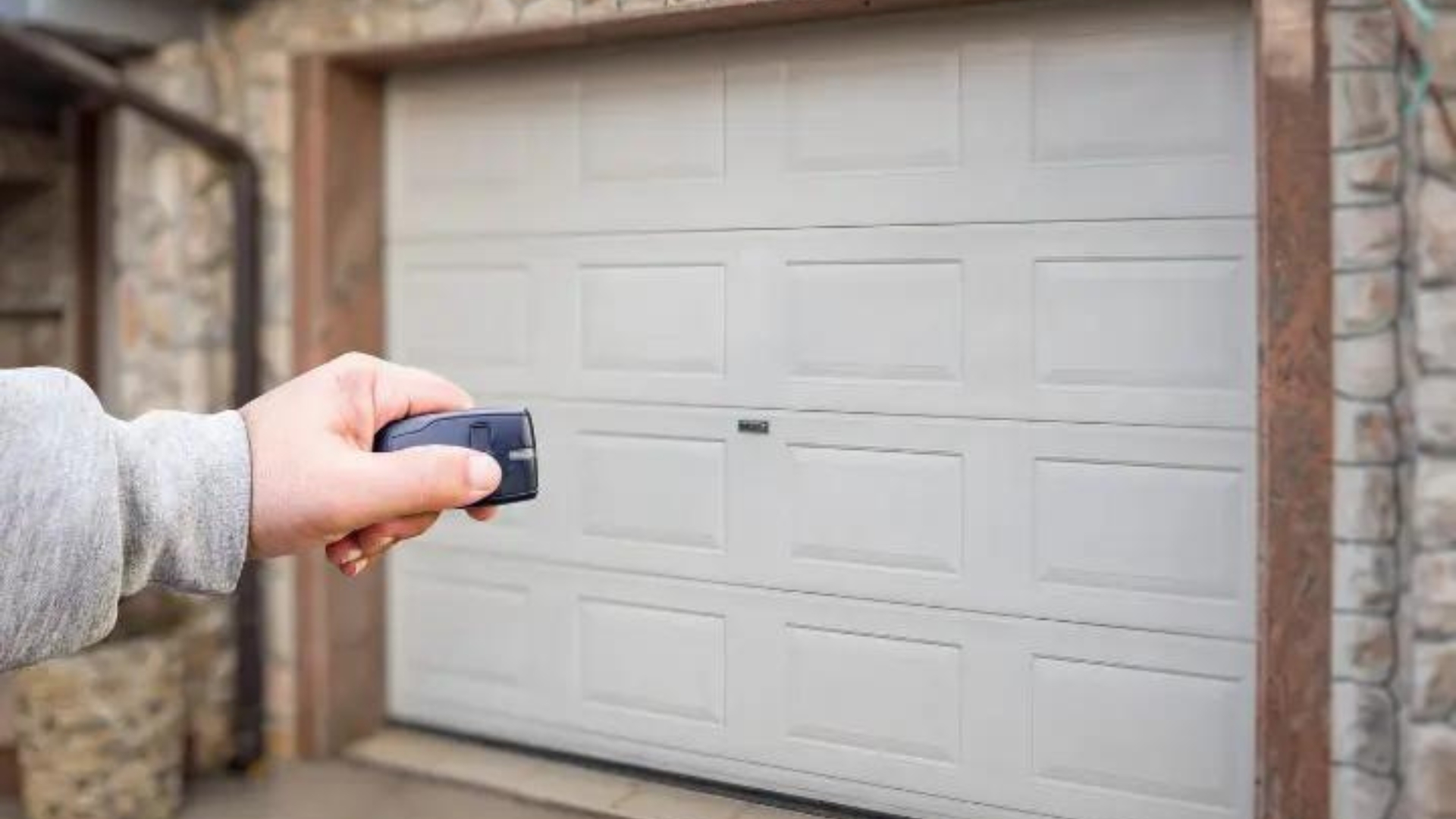 A woman pressing the garage door remote control