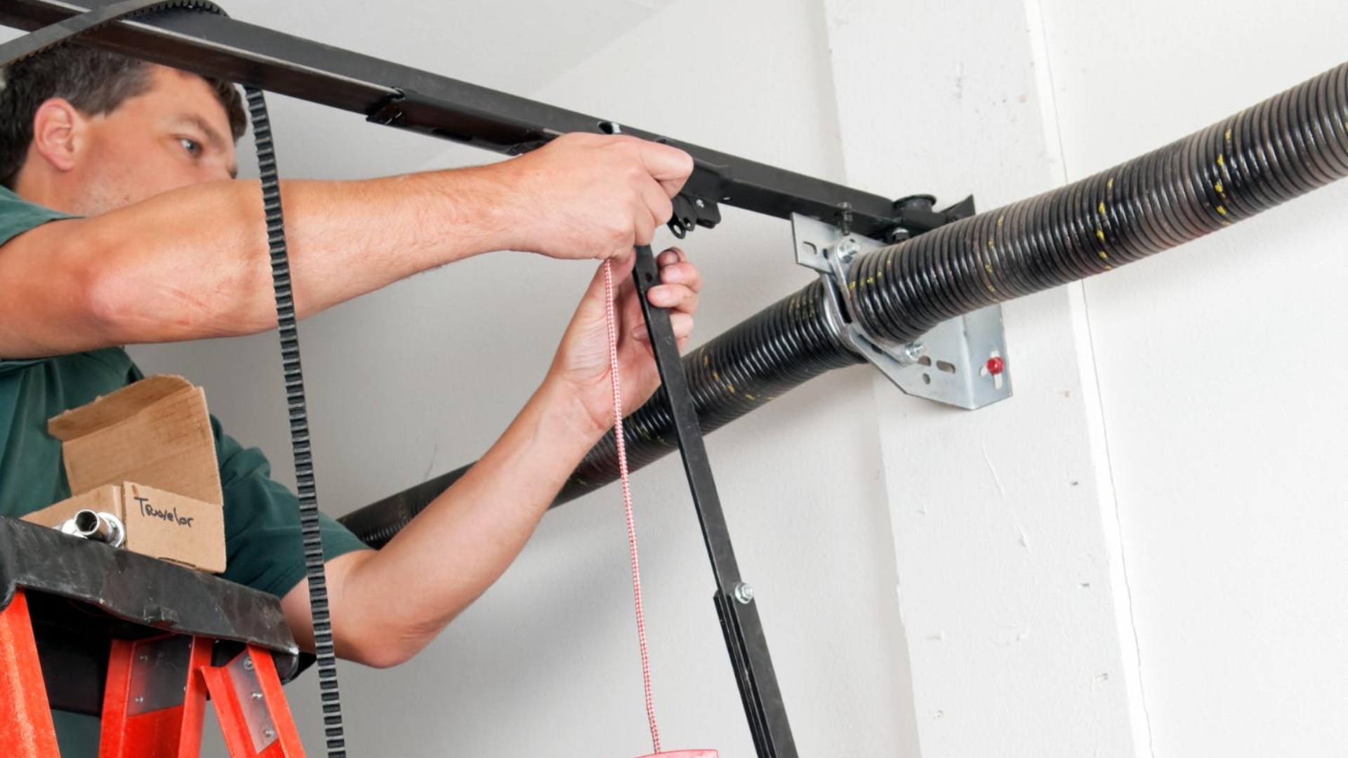 A garage door technician adjusting the spring