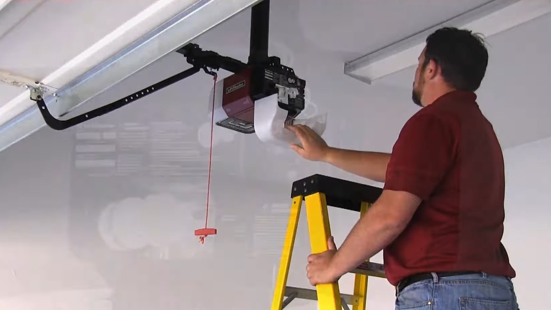 A technician performing a garage door opener maintenance