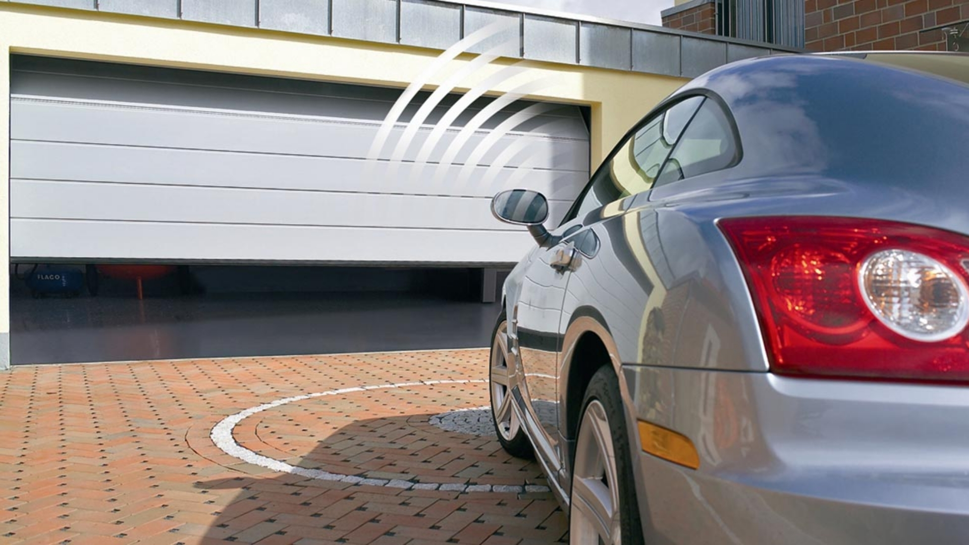 Car approaching a garage with remote-controlled access.