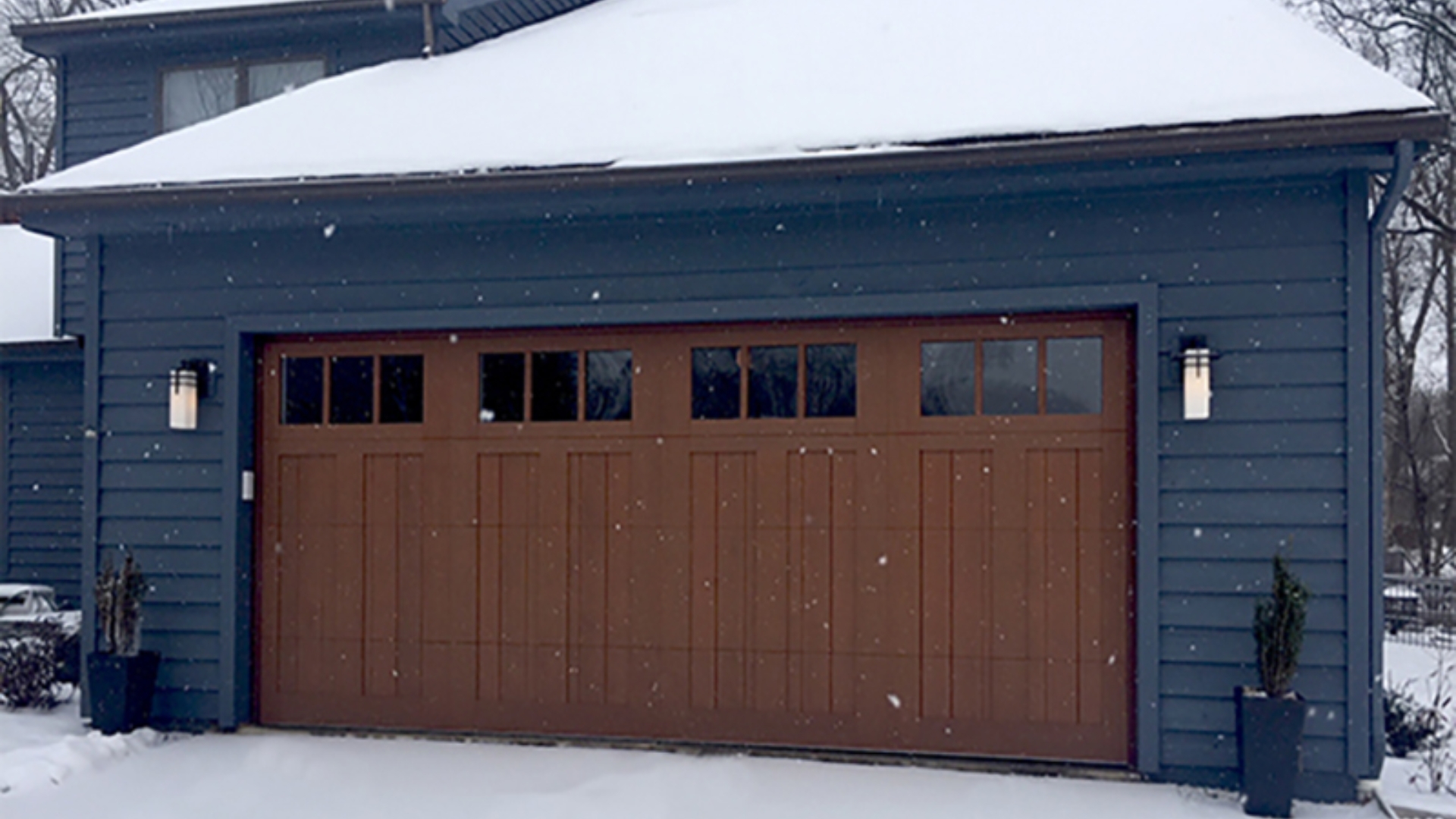 Insulated garage door providing warmth during winter snowstorms