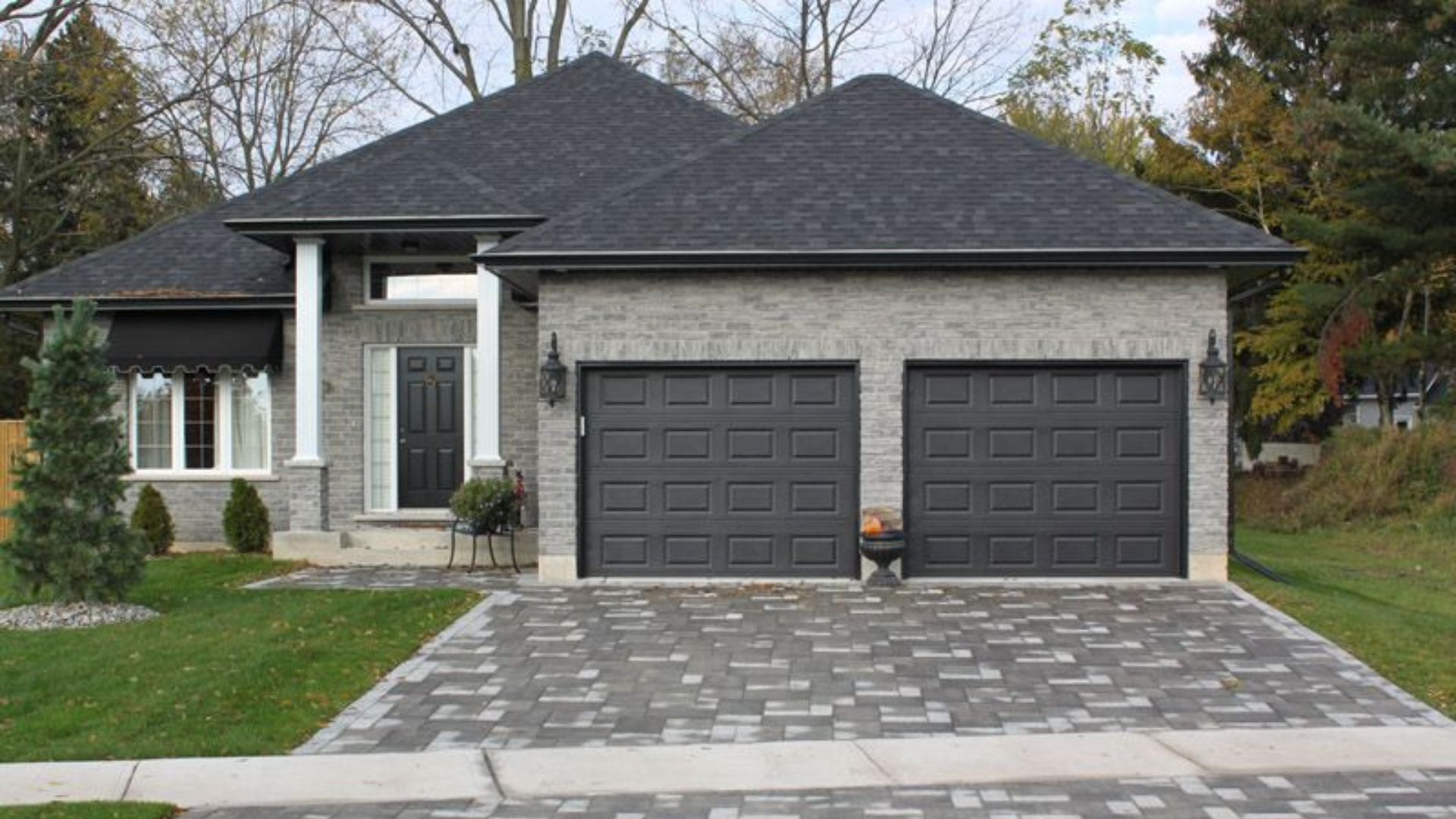 A modern home with stylish dark-colored painted garage doors.