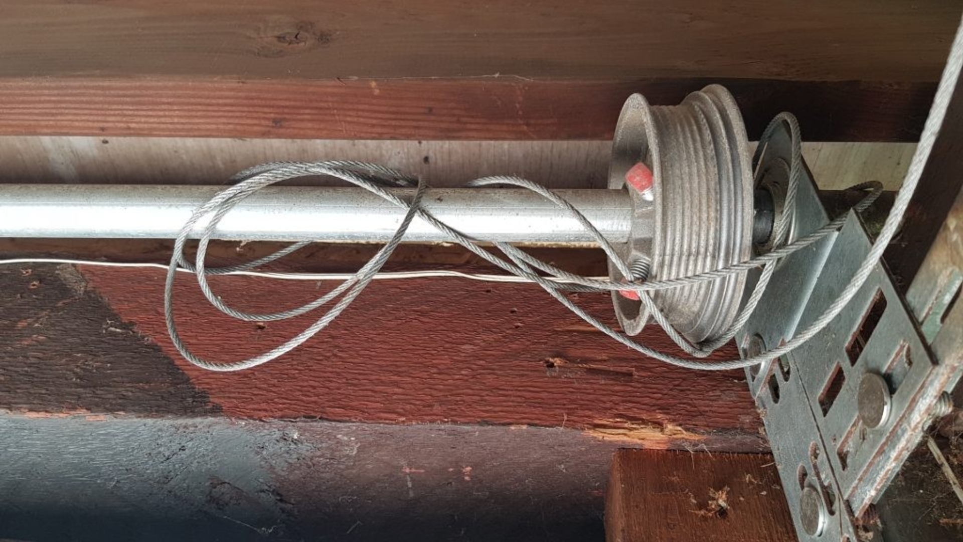 A tangled garage door cable causing issues with door movement.