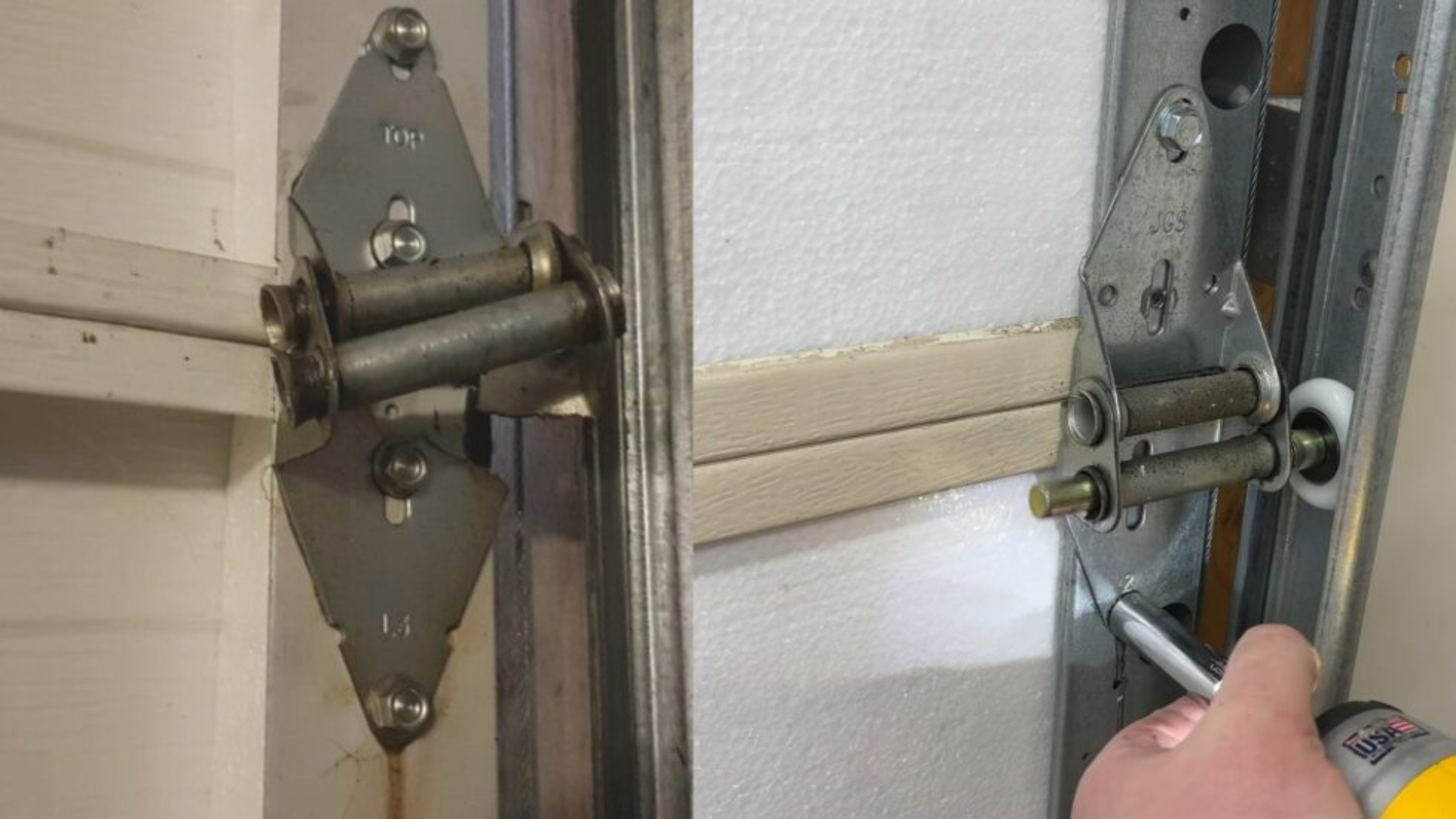 Replacing garage door rollers and hinges to solve a slow-moving door issue