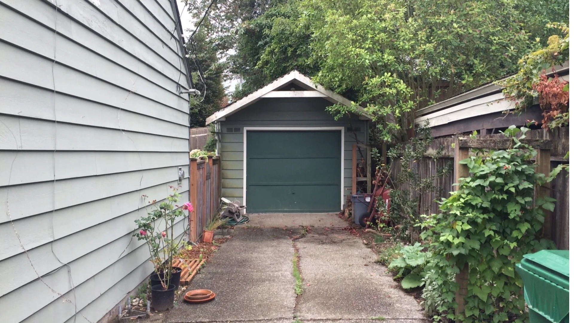 A small backyard garage with a single-car door.