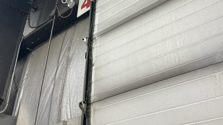 Close-up of insulated overhead garage door panels during maintenance service on Grand Ave, Des Moines, IA